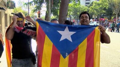 Men holding a Catalan flag