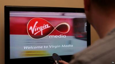 A man looking at a Virgin Media welcome screen