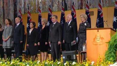 Officials on stage with Australian flags
