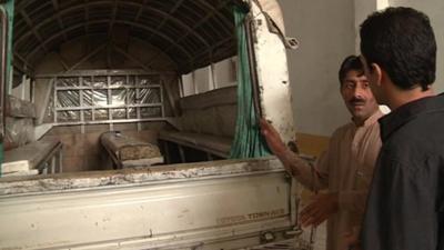 The BBC's Aleem Maqbool is shown the truck Malala was travelling in when she was shot in Mingora, Pakistan