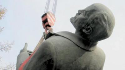 Lenin statue dangling from crane