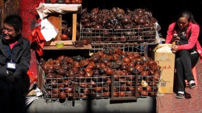 Vendors selling tea pots and sculptures at a market in central Beijing October 11, 2012