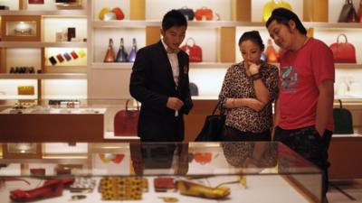 A couple shopping at a Louis Vuitton store in Shanghai