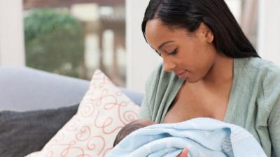 young woman breastfeeding her baby