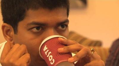 Indian coffee-drinker drinking Costa coffee