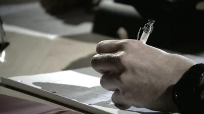 Person writing notes about visa