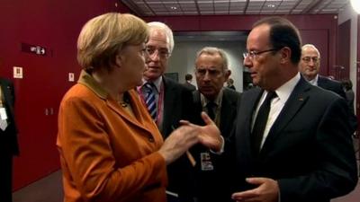 Angela Merkel and Francois Hollande talking