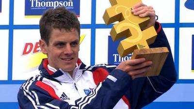 Jonny Brownlee lifts the trophy