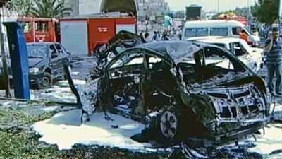 Burnt-out car following explosion in Damascus