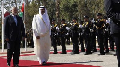 Hamas Prime Minister Ismail Haniya and the Sheikh Hamad bin Khalifa Al Thani of Qatar during a welcoming ceremony at the Rafah border crossing with Egypt in the southern Gaza Strip, 23 October 2012