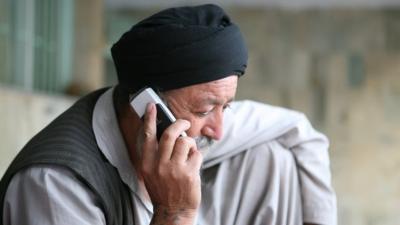 Man uses mobile phone in Kabul