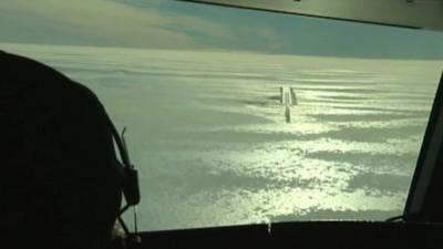 Pilot looks over runway in Antarctica