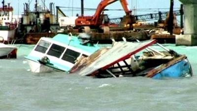 Damaged boats floating in waters in Nassau