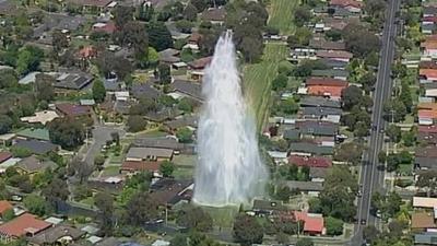 Fountain of water from burst water pipe