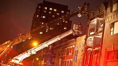 Firefighters at scene of damaged building