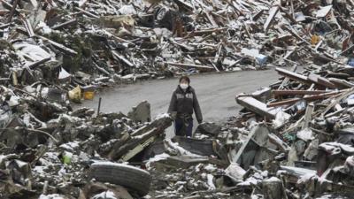 Person surrounded by rubble