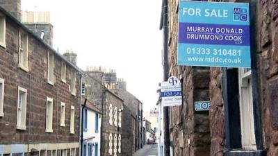 'For sale' signs on houses