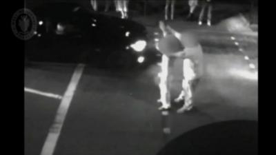 Police footage of man and boy starting car race