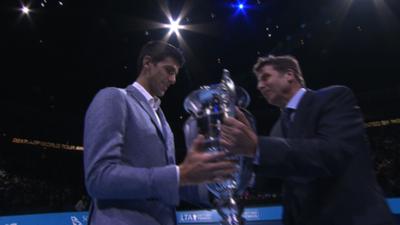 Novak Djokovic is presented with the world number one trophy