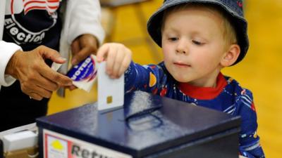 child helping parent vote in Nevada