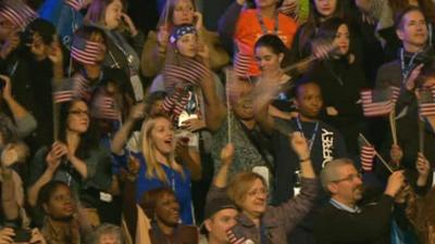 Crowds wave flags