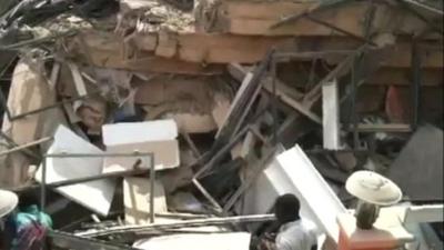 People looking at rubble in Accra