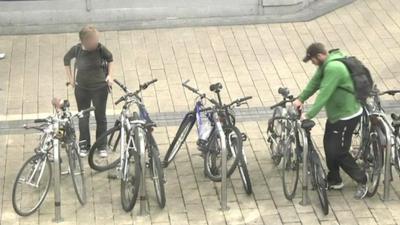 Police officer (right) posing as bike thief