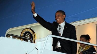 President Barack Obama waves as he exits Air Force One, 7 November 2012
