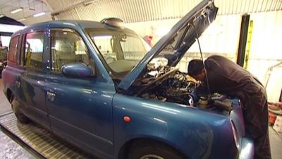 London taxi in a garage