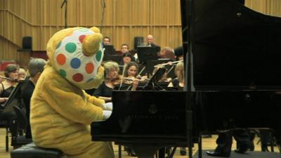 Pudsey plays the piano