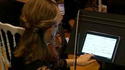 A musician using the tablet computer during a performance