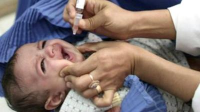 Baby being given oral vaccine