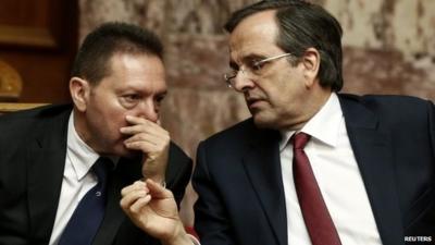 Greek Finance Minister Yannis Stournaras (left) talks with Prime Minister Antonis Samaras ahead of the vote in Athens. Photo: 11 November 2012