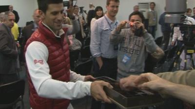 Novak Djokovic hands out chocolates