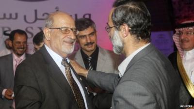 Haitham al-Maleh (left) shakes hands with Moaz al-Khatib in Doha (11 November 2012)