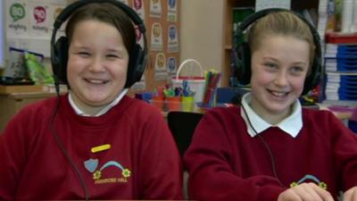 Schoolchildren listening to music