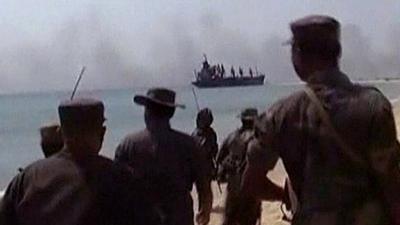 Sri Lankan military looking towards smoke from a battle