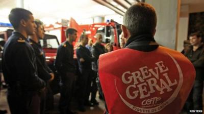 Firefighters in a picket line at their Lisbon headquarters in Portugal, 13 November 2012. The vest reads 'General strike'