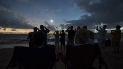 People watch the solar eclipse.