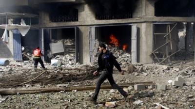 Man walks past rubble