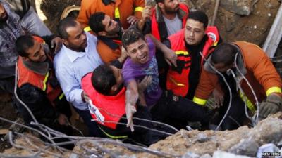 A man being saved after his house was destroyed in an Israeli air strike, Gaza City, 18 Nov 2012