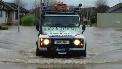 Ambulance driving in flood