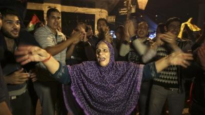 Palestinians celebrate the ceasefire, which they say is a victory over Israel