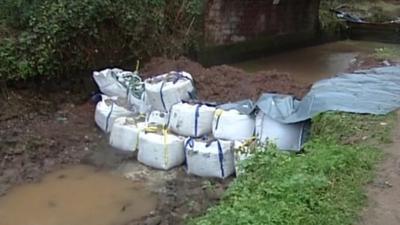 Sandbags beneath a bridge at Halberton in Devon