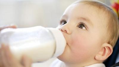 baby being fed by bottle