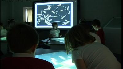 Pupils at interactive school desks