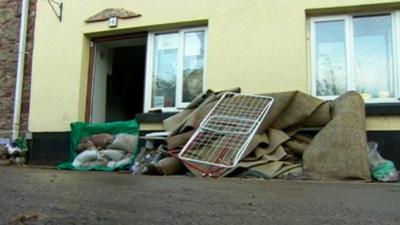 Damaged carpet and possessions outside house