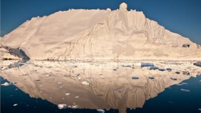 An iceberg and its reflection in Disko Bay, Greenland