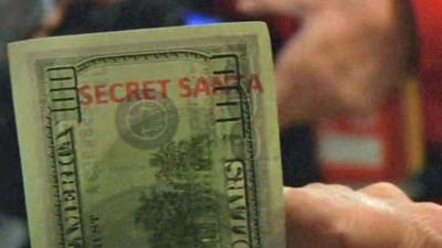 One of the specially-marked 'Secret Santa' $100 bills