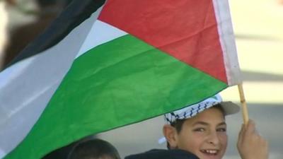 Palestinian boy celebrates the vote